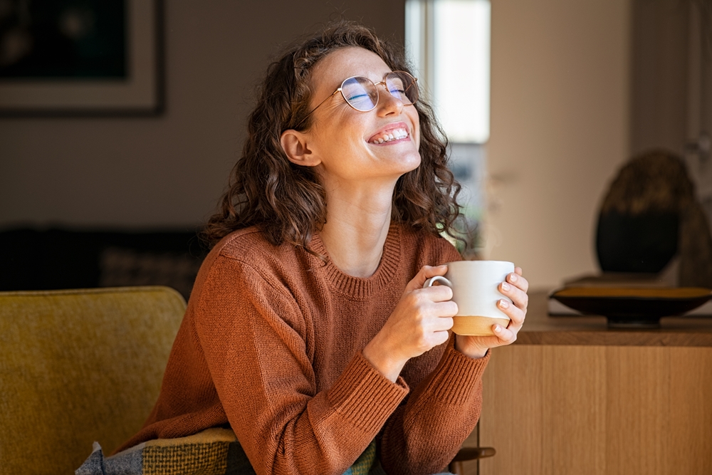 Geld vermehren mit der 6-Konten-Regel, Frau mit Kaffee lächelt